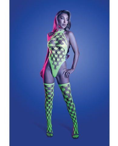 A model poses in a neon green bodysuit with matching fishnet thigh-high stockings against a blue studio background.