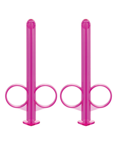 Two pink lube tubes facing up.