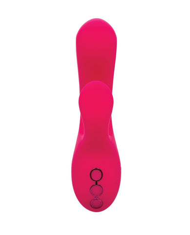 A bright hot pink personal massager with a curved, ergonomic design and three circular control buttons on the underside, shown against a solid white background.