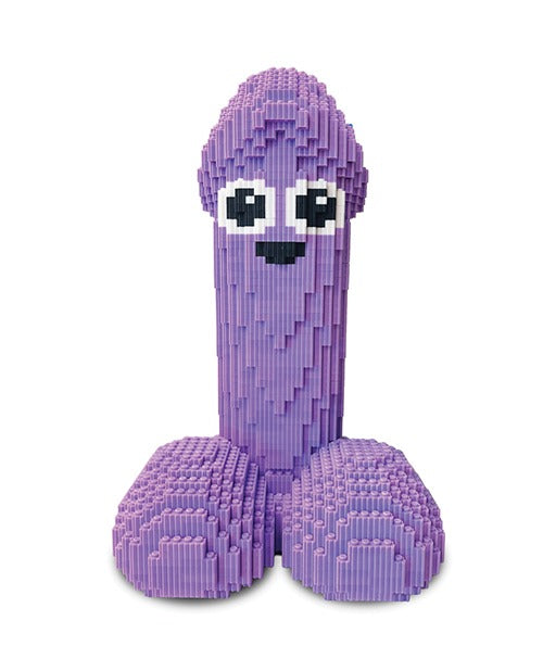 A purple toy structure resembling a stylized penis made of interlocking block-like pieces, with large black-and-white eyes and a small black mouth, shown on a plain white background.