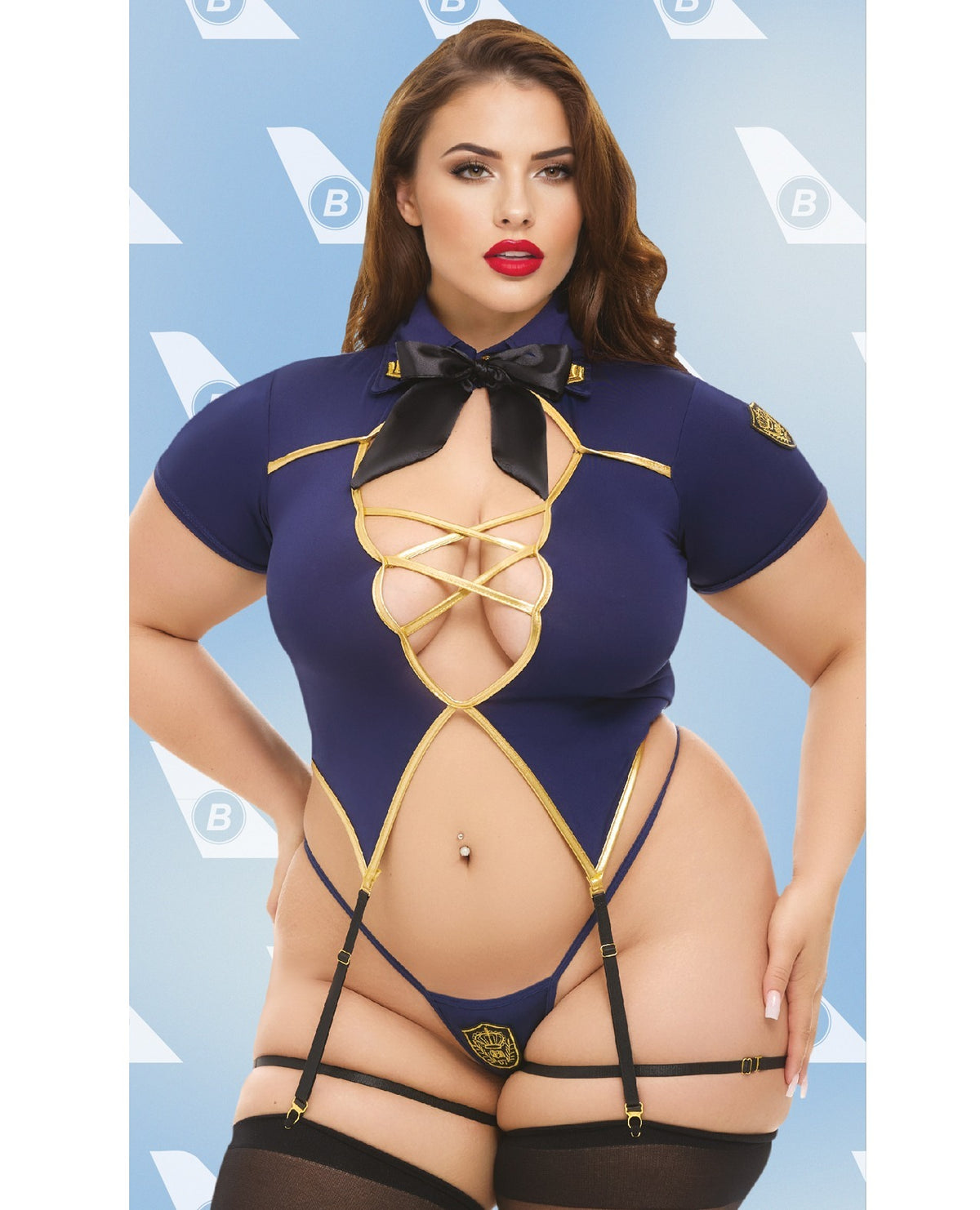 A woman modeling a revealing navy blue and gold lingerie bodysuit with a black bow at the collar, strappy lace-up front, and black garter-style thong with thigh straps and black stockings, against a light blue patterned backdrop.