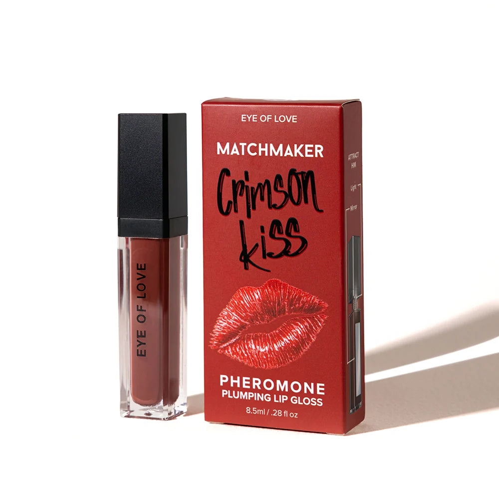 Matchmaker Eye of Love Crimson Kiss Pheromone Plumping Lip Gloss shown next to its red packaging box on a white background.