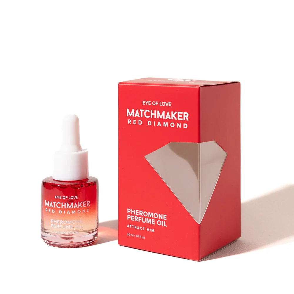 A bottle of Eye of Love Matchmaker Red Diamond Pheromone Perfume Oil next to its red packaging box on a clean white background.