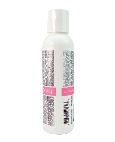 White bottle with text and a pink label on a white background