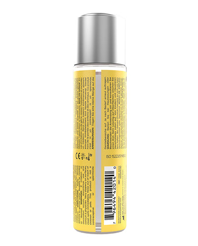 Bottle with yellow label and silver cap on a white background