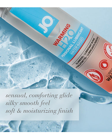 JO warming H2O personal lubricant bottle with water droplets on a blue background