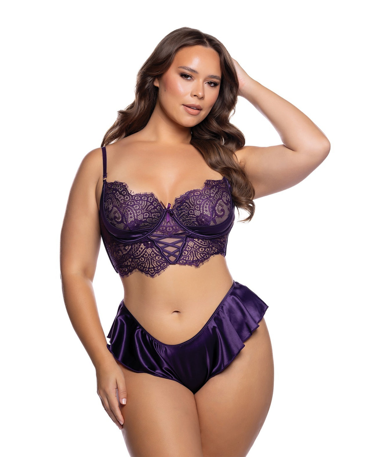 A woman modeling a two-piece purple lingerie set against a plain white background. The set includes a lace underwire bra and matching ruffled high-waisted briefs.
