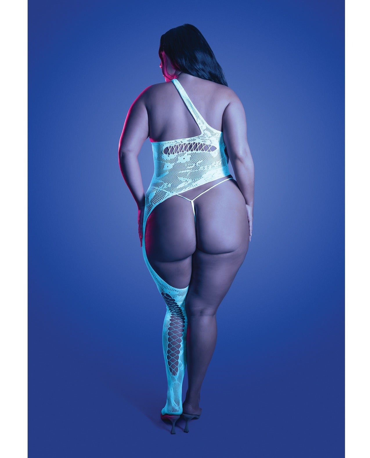 A plus-size model is shown from behind wearing a light blue and white patterned one-shoulder bodysuit with a matching thigh-high fishnet stocking, set against a solid blue studio background.