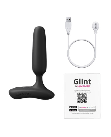 A black silicone personal massager with a USB charging cable and a white Lovense Glint app card on a plain white background.