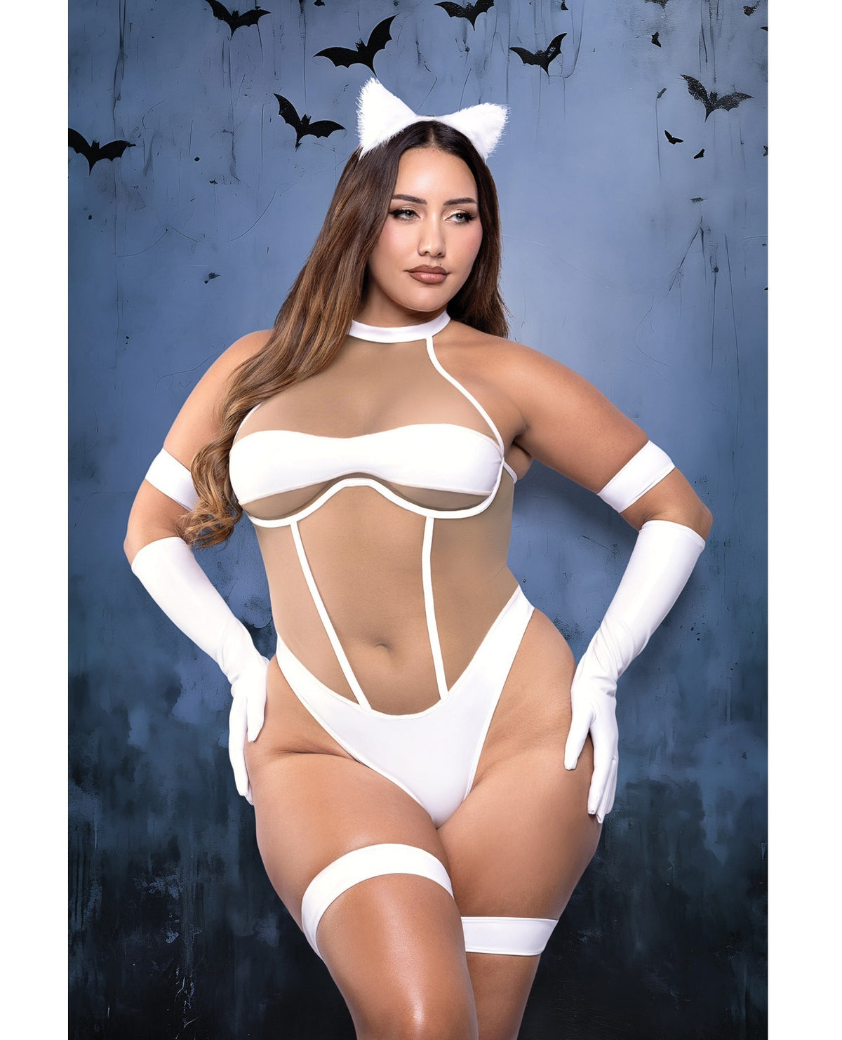 A woman modeling a white cat-themed lingerie costume set against a dark blue background with bat silhouettes. The set includes a strappy white bodysuit, matching white thigh-high stockings, white arm cuffs, a white choker, white thigh bands, and white cat ears on a headband.