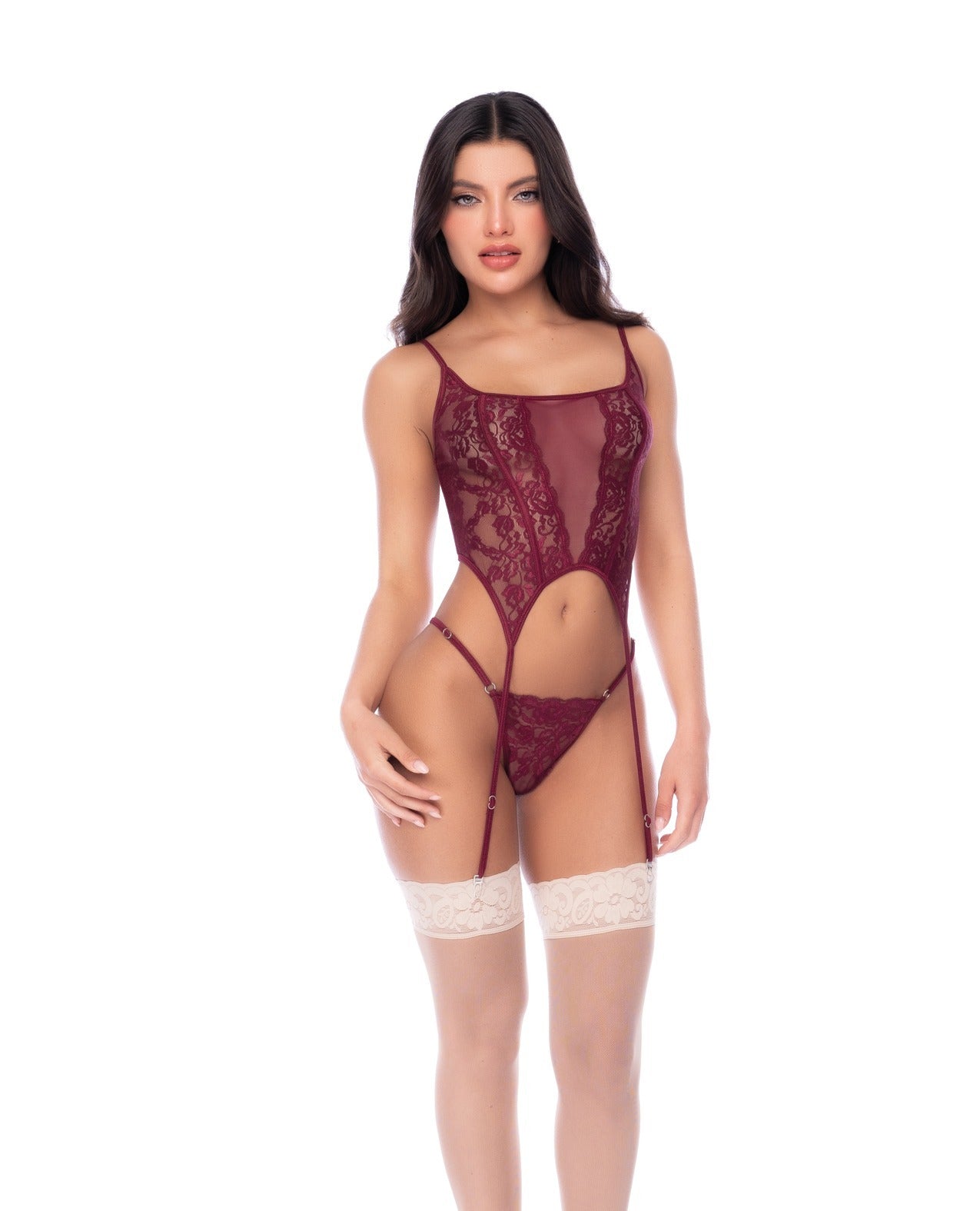 A woman modeling a burgundy lace and mesh garter lingerie with thigh-high lace garter stockings, photographed against a solid white background.