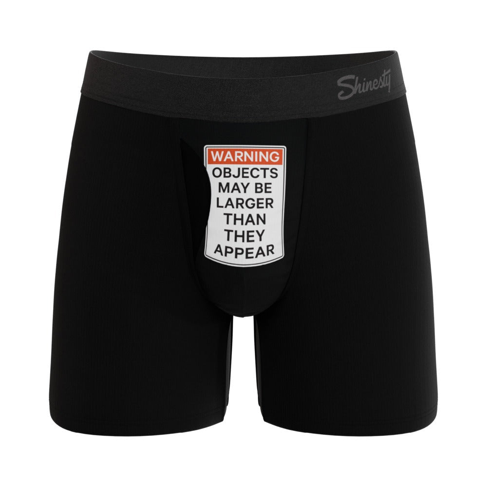 Black boxer briefs with a humorous warning label on a white background