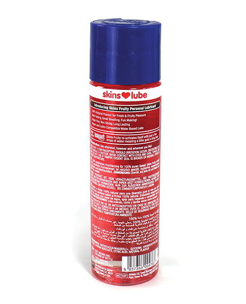 Skins Lube bottle with red label and blue cap on a white background