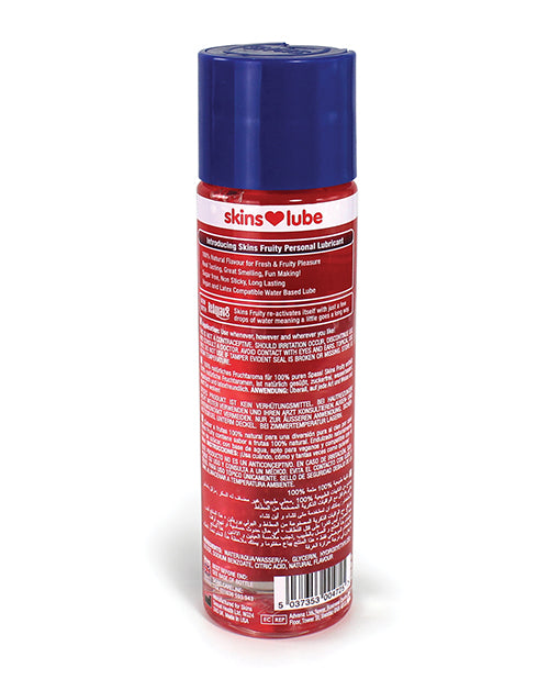 Skins Lube bottle with red label and blue cap on a white background