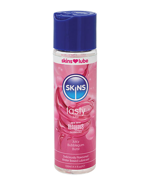 Pink bottle of Skins tasty lubricant with blue cap on a white background
