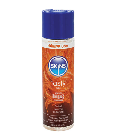 Skins lubricant bottle with blue cap and orange label on a white background