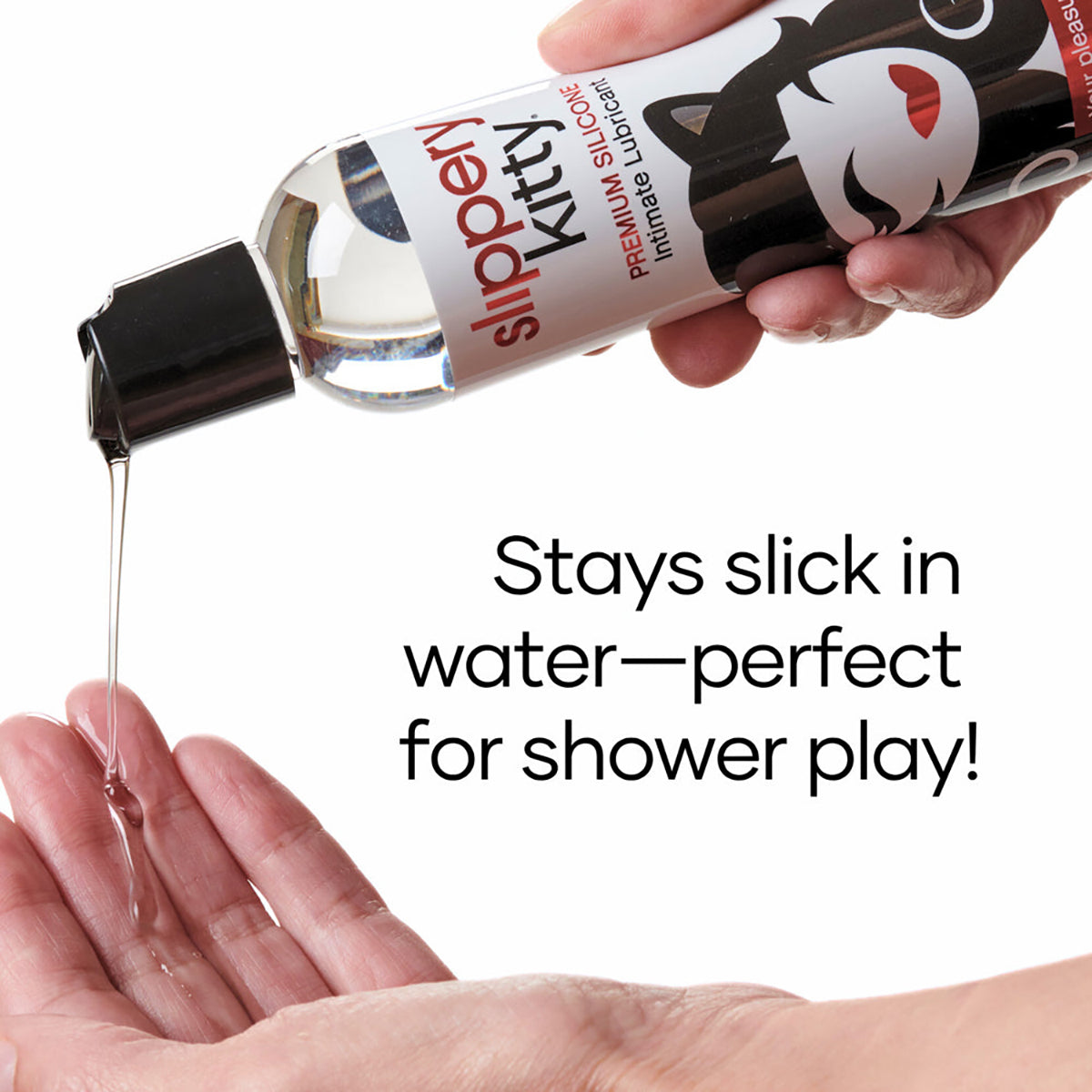 Bottle of Slippery Kitty silicone lubricant being poured onto a hand with text 'Stays slick in water-perfect for shower play!'.