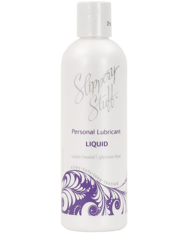A bottle of Slippery Stuff Liquid. The bottle is pearlescent and has a purple swirly design at the bottom.