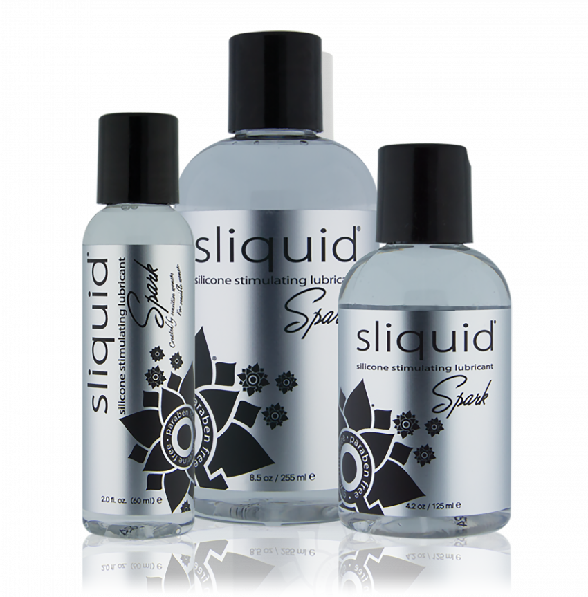 Three bottles of Sliquid Spark lubricant on a white background