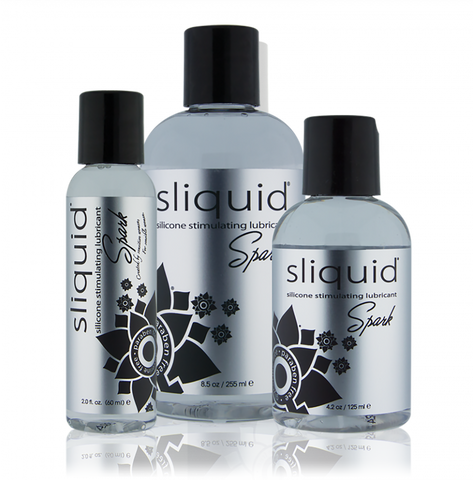 Three bottles of Sliquid Spark lubricant on a white background