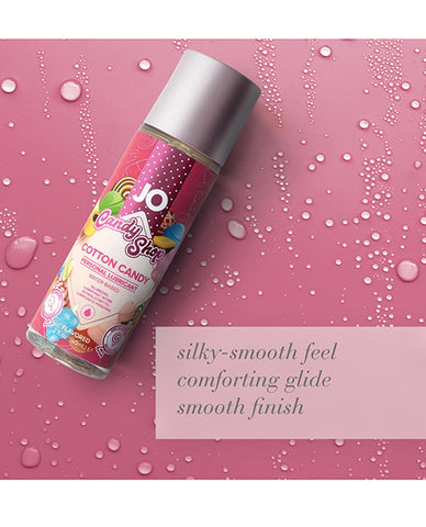JO Candy Shop Cotton Candy personal lubricant bottle on a pink background with water droplets.