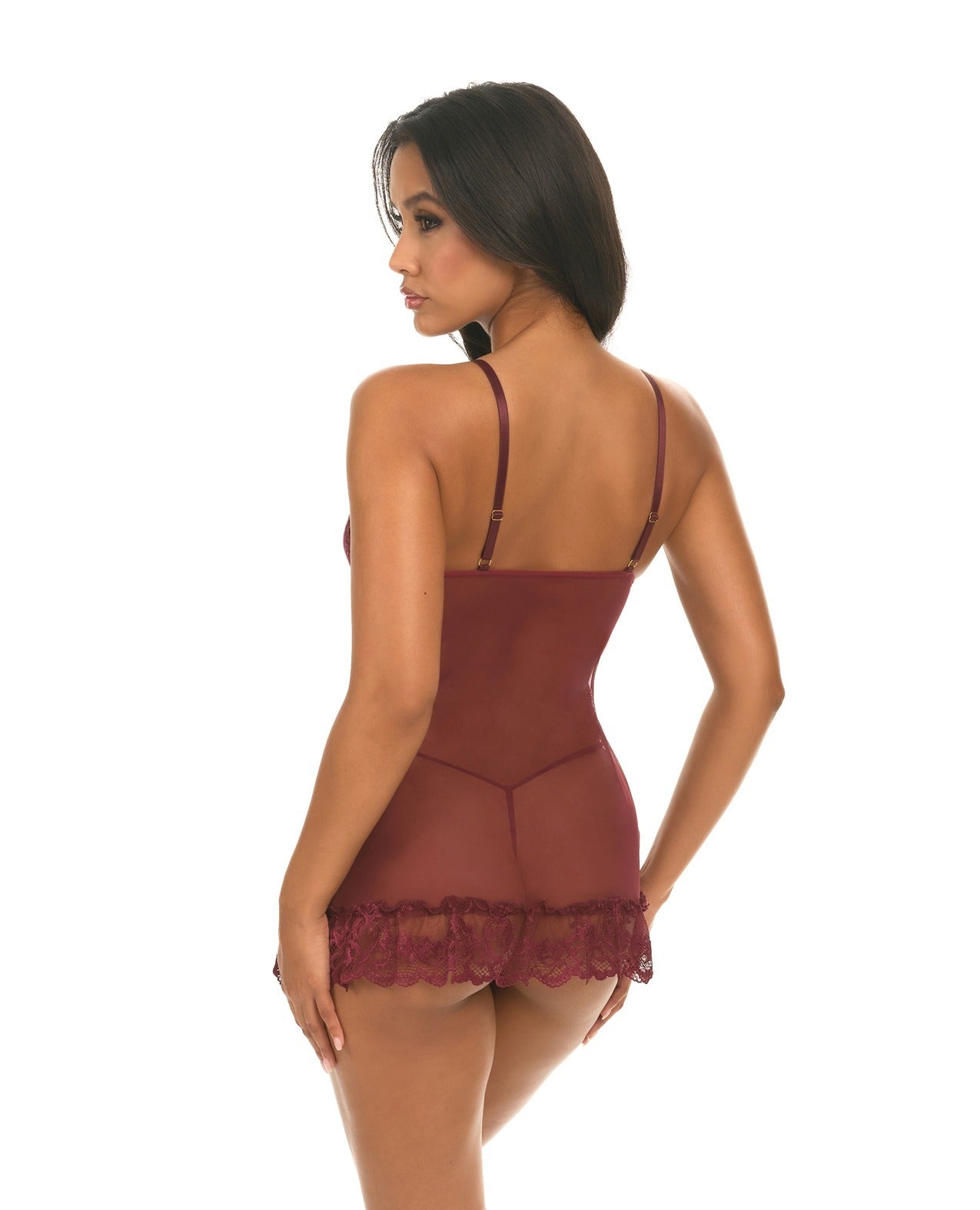 A woman modeling a sheer burgundy lace babydoll lingerie chemise from the back against a plain white background.