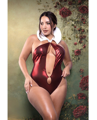 A woman modeling a shiny metallic burgundy one-piece swimsuit with a white collar, posed against a vintage-style green floral wall.