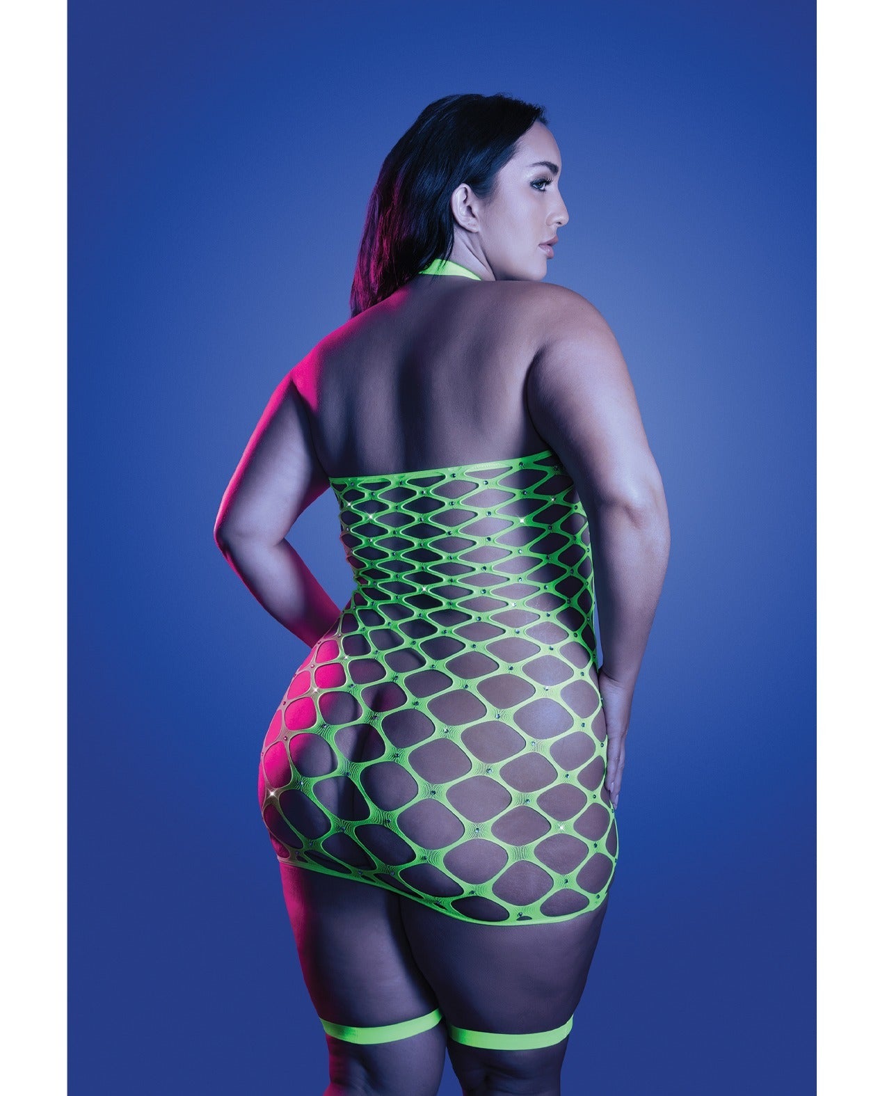 A woman shown from the back wearing a neon green fishnet halter bodysuit with matching thigh bands, posed against a blue studio background.