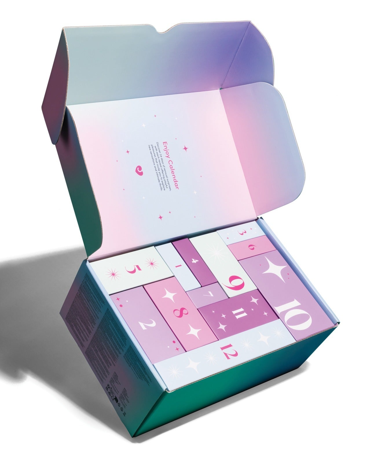 An open iridescent gift box with a pastel gradient exterior and a pink-and-white advent calendar inside, photographed on a clean white background.